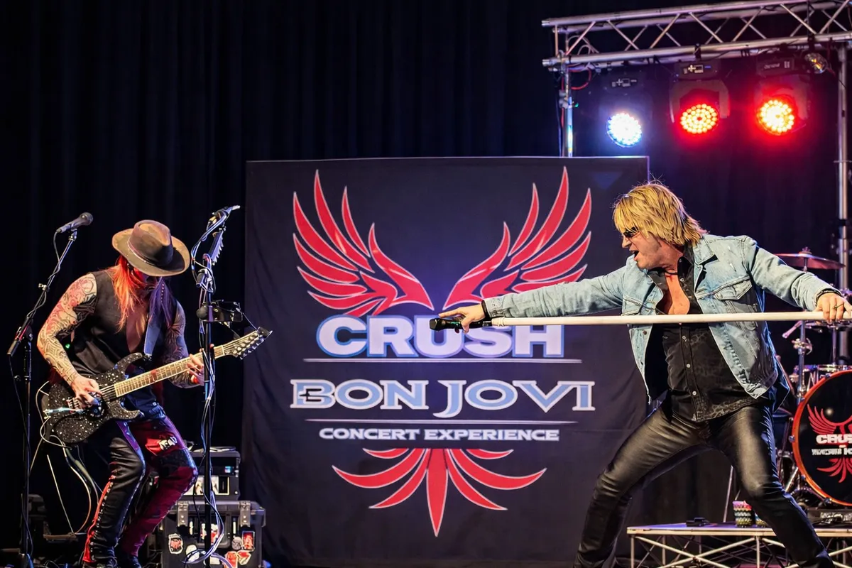 The stage set with the Crush winged logo banner behind the band